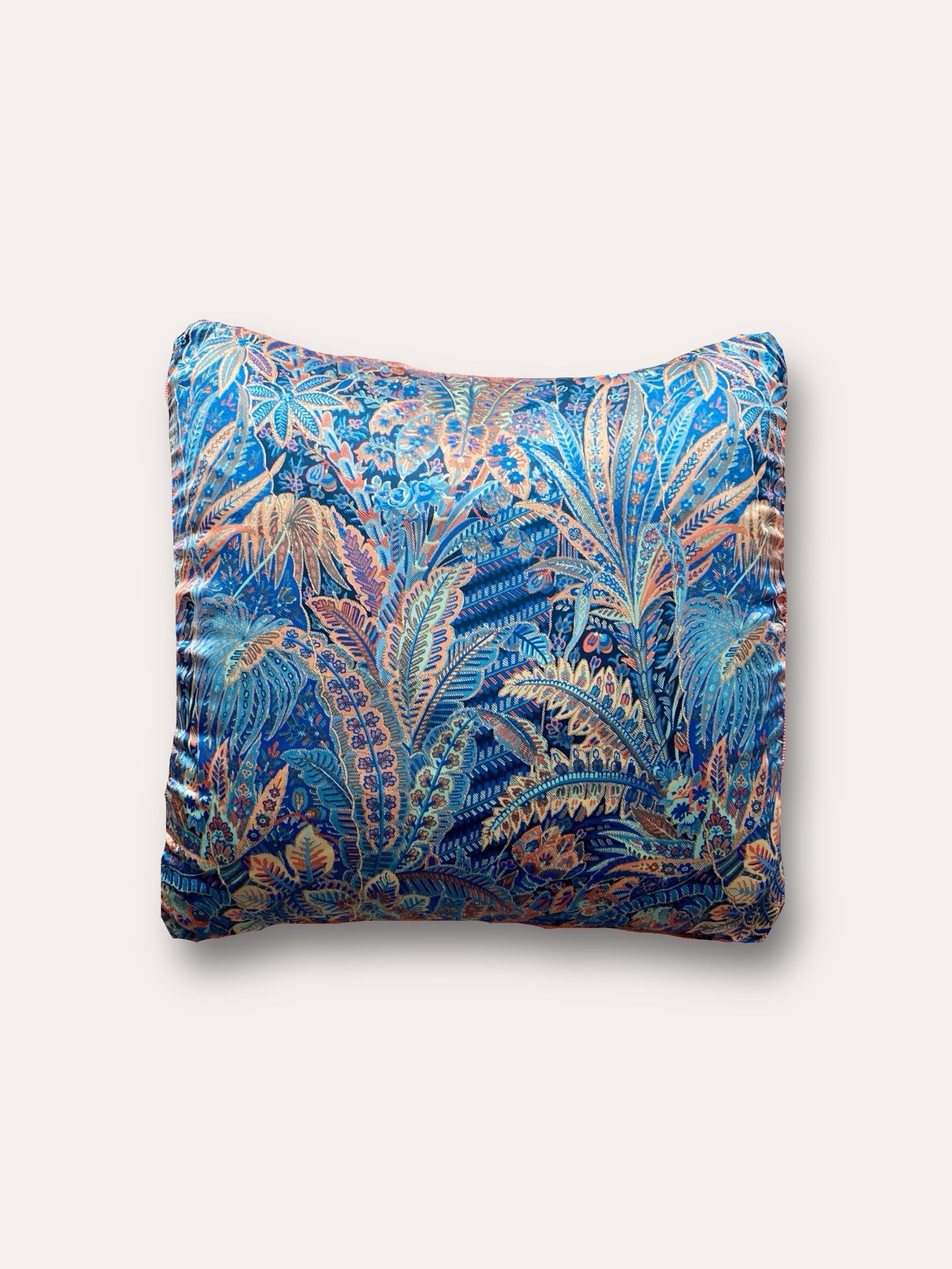 Close-up image of a Liberty Fabric Adelphi Voyage Silk Cushion. The cushion features intricate patterns on luxurious silk fabric, offering a touch of elegance and sophistication to any home decor.