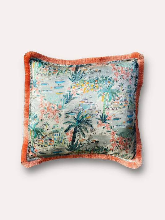 Close-up image of a Liberty Fabric Cape Vista Silk Cushion with a coral orange fringe edge. The cushion showcases intricate patterns on luxurious silk fabric, adding vibrancy and elegance to any home decor.