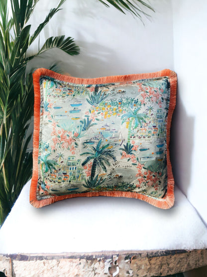 Close-up image of a Liberty Fabric Cape Vista Silk Cushion with a coral orange fringe edge. The cushion showcases intricate patterns on luxurious silk fabric, adding vibrancy and elegance to any home decor.