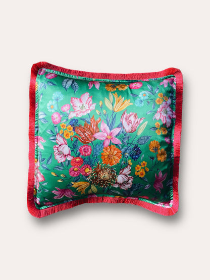 Close-up image of a Liberty Fabric Stately Bouquet Silk Cushion with a fuchsia pink fringe edge. The cushion features intricate floral patterns on luxurious silk fabric, adding vibrancy and elegance to any home decor.